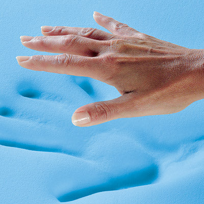 A women's hand pressing into a bloc k of CoolSense cooling foam.